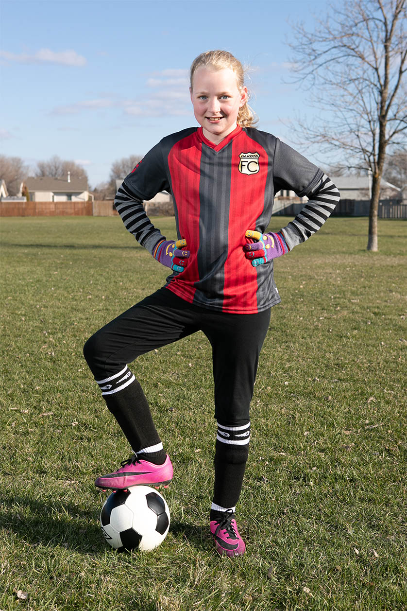 Full body soccer photo on soccer pitch